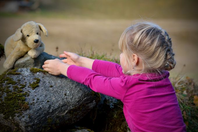 child with dog toy